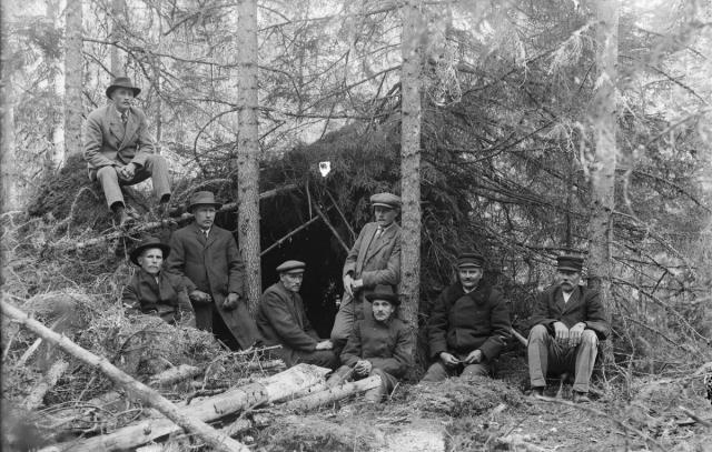 ihmisiä vartiossa metsässä